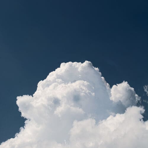Large white clouds over blue sky