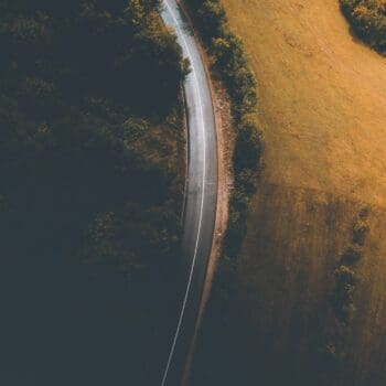 Aerial view of a road between fields