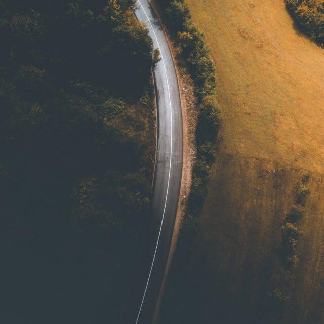 Aerial view of a road between fields