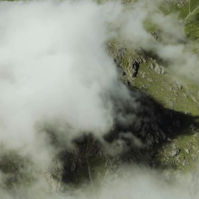 Fog rolling over green mountains